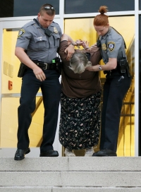 Pro-lifer, Joan Andrews, arrested after refusing to leave the entrance to the “black mass” at Civic Center Music Hall in Oklahoma City